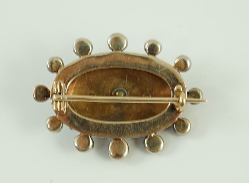 A 19th century gold, blue enamel and rose cut diamond set oval brooch